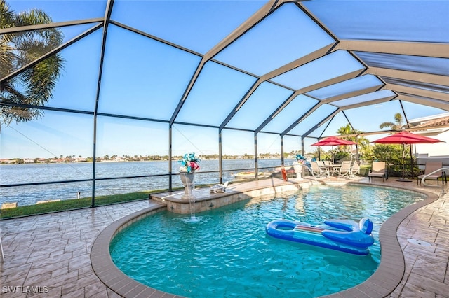 view of pool with pool water feature, a patio, a water view, and glass enclosure