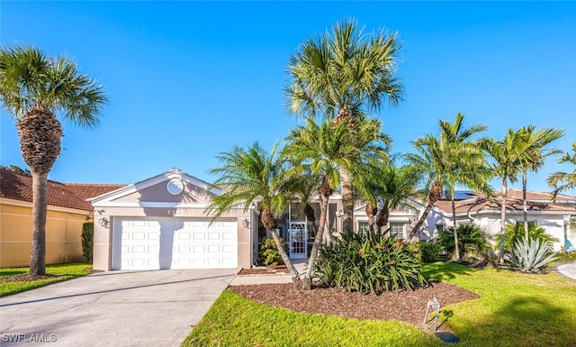 view of front of home featuring a garage and a front lawn