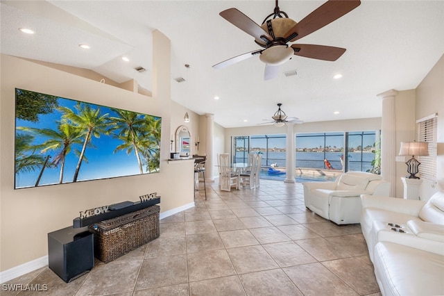 tiled living room featuring vaulted ceiling, ceiling fan, and a water view