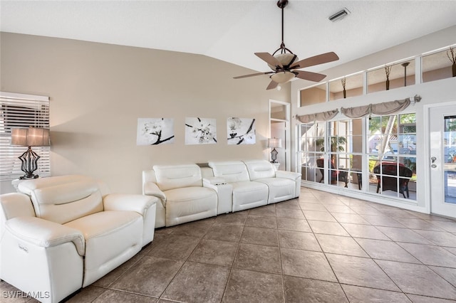 unfurnished living room with ceiling fan, tile patterned floors, and vaulted ceiling