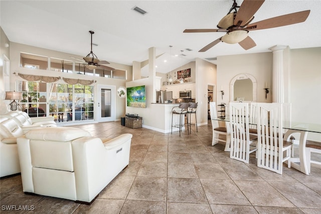 tiled living room with vaulted ceiling and ceiling fan