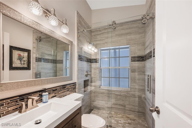 bathroom with tile walls, tasteful backsplash, vanity, an enclosed shower, and toilet