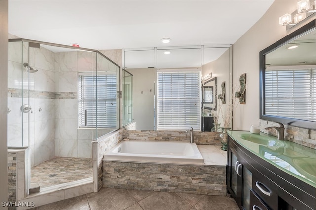 bathroom with vanity and shower with separate bathtub