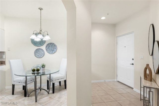 dining room with light tile patterned flooring and a notable chandelier