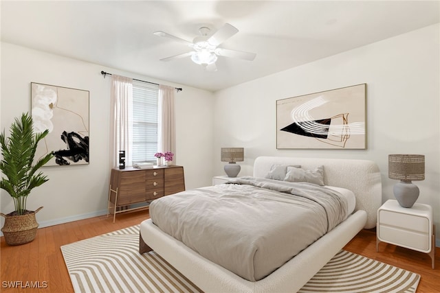 bedroom with wood-type flooring and ceiling fan