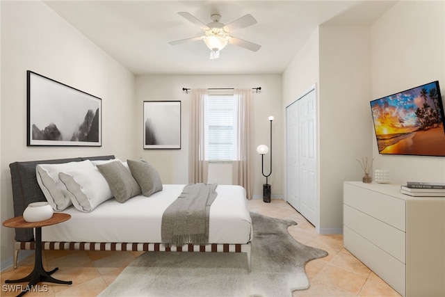 bedroom with a closet, ceiling fan, and light tile patterned flooring