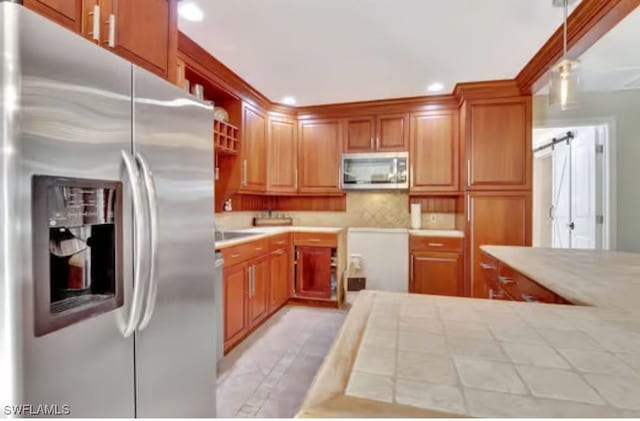 116 Capri Blvd, Naples, FL 34113 - kitchen with recessed lighting, decorative backsplash, tile counters, appliances with stainless steel finishes, and decorative light fixtures
