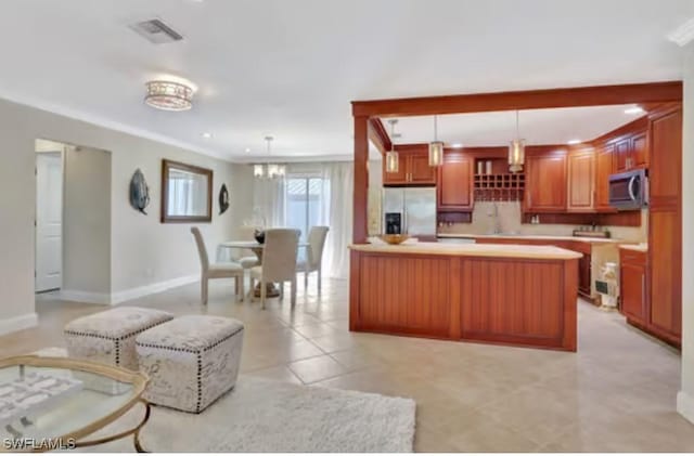 116 Capri Blvd, Naples, FL 34113 - kitchen featuring visible vents, light countertops, light tile patterned floors, appliances with stainless steel finishes, and hanging light fixtures