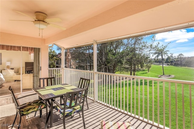 sunroom featuring ceiling fan