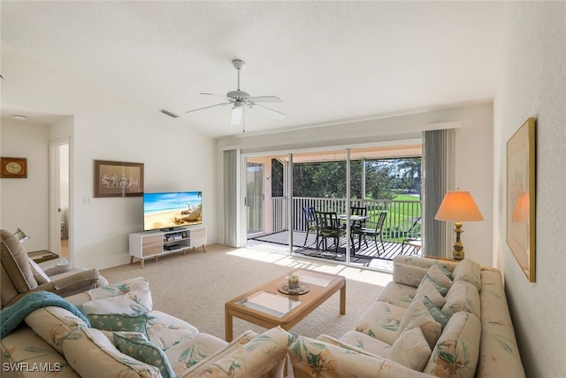 carpeted living room featuring vaulted ceiling and ceiling fan