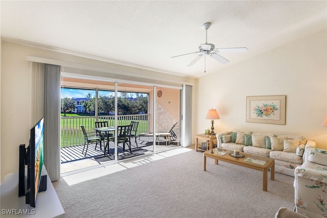 living room featuring lofted ceiling, a textured ceiling, light colored carpet, and ceiling fan