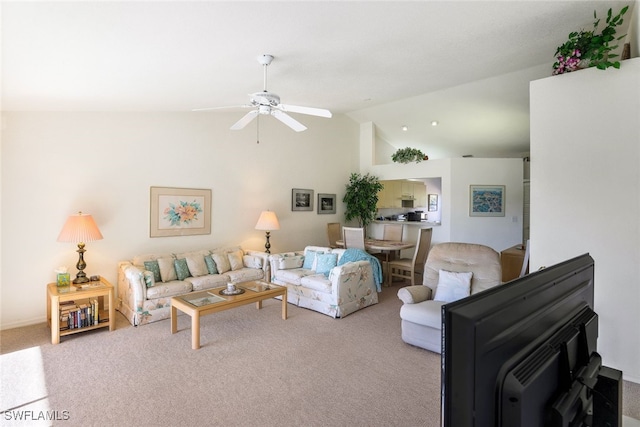 carpeted living room with lofted ceiling, a wood stove, and ceiling fan