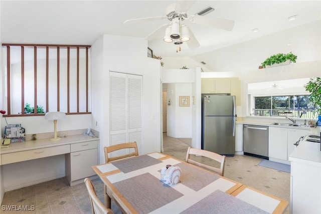 dining area with vaulted ceiling, ceiling fan, built in desk, and sink