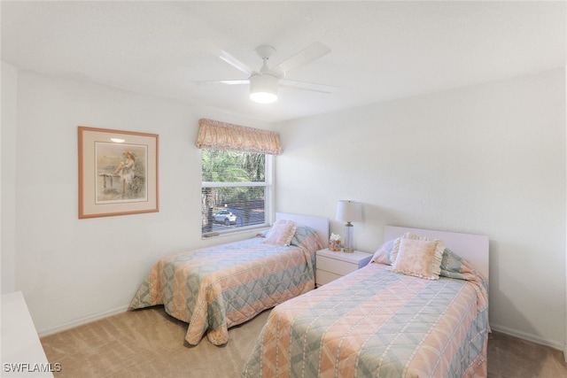 bedroom featuring ceiling fan and carpet