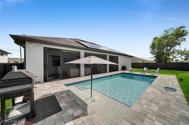 view of swimming pool featuring a patio, a grill, and a yard