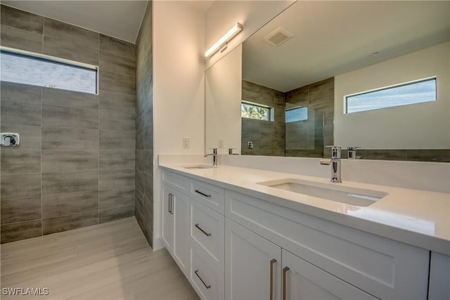 bathroom featuring vanity and a tile shower