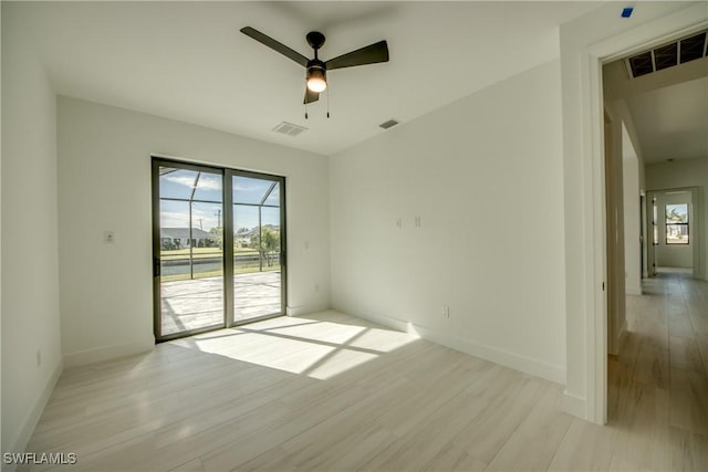 empty room featuring ceiling fan and light hardwood / wood-style floors