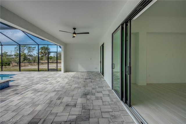 view of patio with glass enclosure