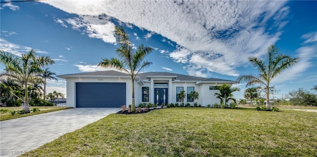 view of front of property with a garage and a front yard