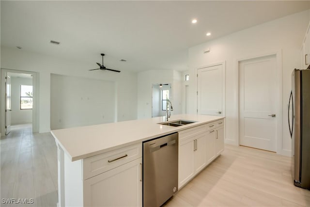 kitchen featuring sink, light hardwood / wood-style flooring, an island with sink, stainless steel appliances, and white cabinets