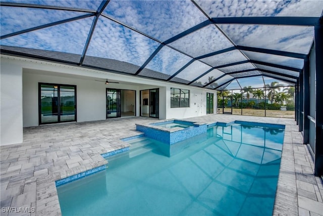 view of swimming pool with an in ground hot tub, a patio, and glass enclosure