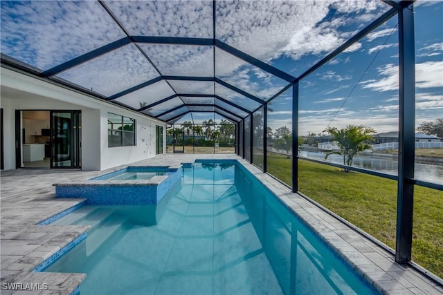 view of pool featuring a lanai, a lawn, a water view, a patio area, and an in ground hot tub