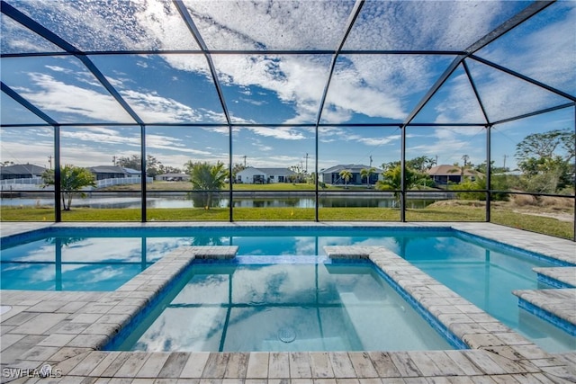 view of pool featuring a lanai, an in ground hot tub, and a water view