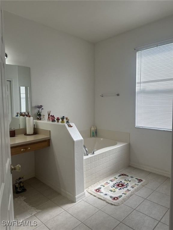 bathroom with tile patterned floors and tiled tub