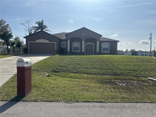 view of front facade with a garage and a front yard