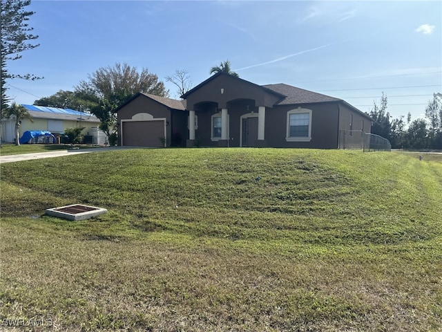 ranch-style home with a garage and a front yard