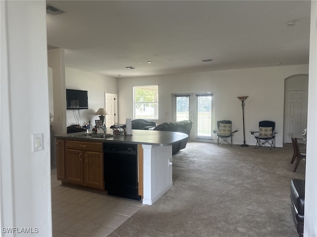 kitchen with dishwasher, sink, and light colored carpet