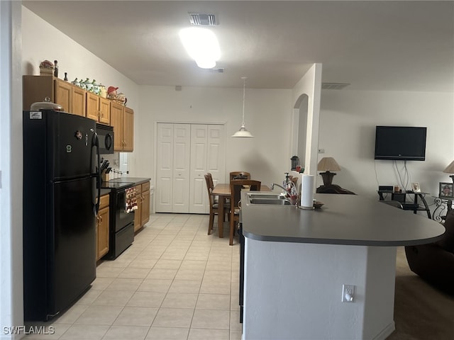 kitchen featuring decorative light fixtures, sink, light tile patterned floors, and black appliances