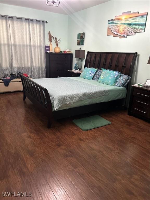 bedroom with dark wood-type flooring