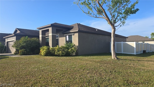 view of property exterior featuring a garage and a yard