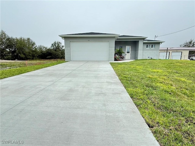 view of front of house with a garage and a front yard