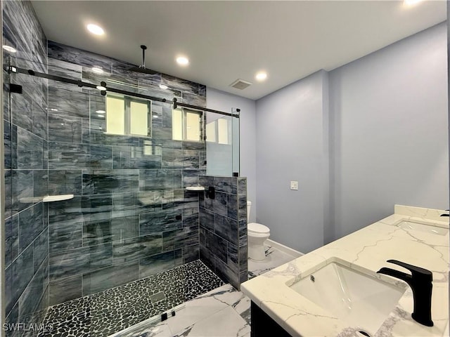 bathroom with vanity, an enclosed shower, and toilet