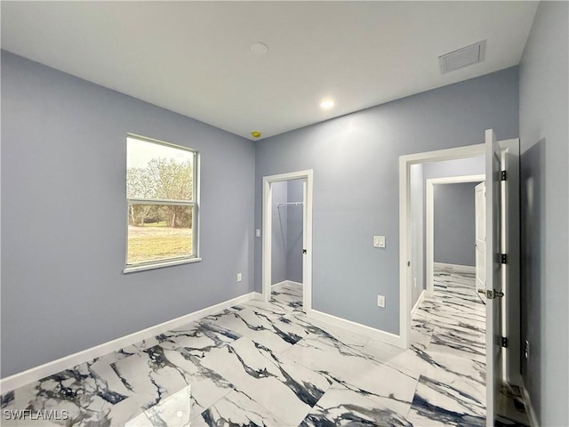 bedroom featuring a spacious closet and a closet