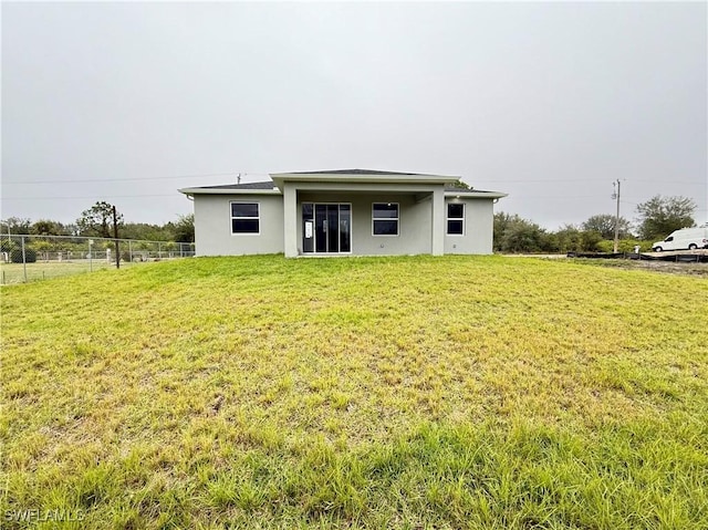 rear view of house with a yard