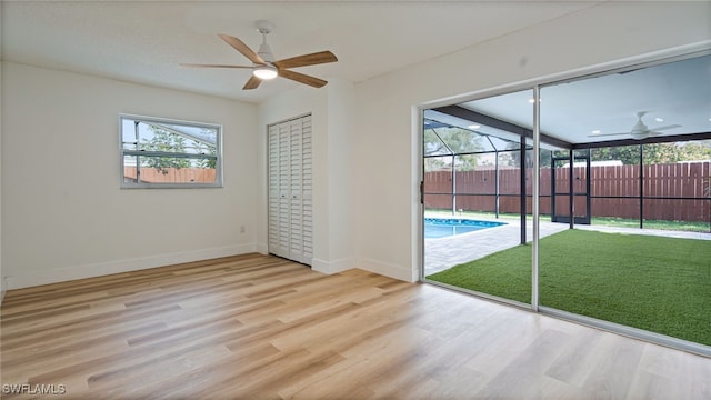 interior space with ceiling fan