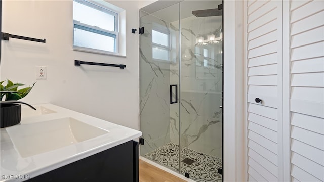 bathroom featuring hardwood / wood-style flooring, vanity, and an enclosed shower