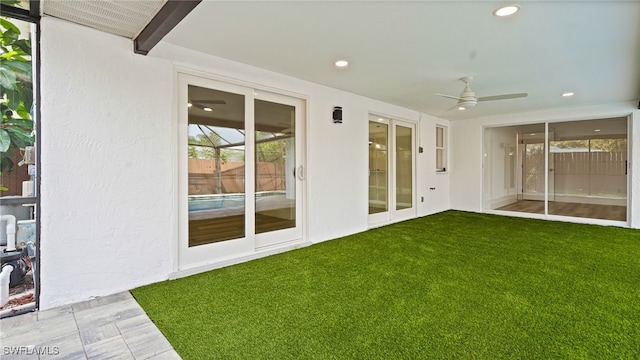 unfurnished sunroom featuring beam ceiling and ceiling fan