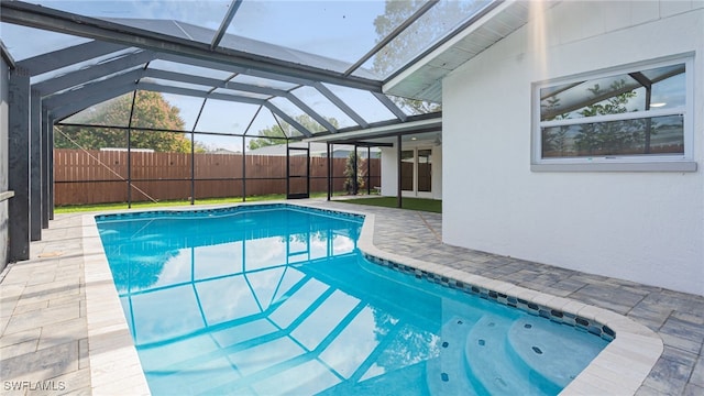 view of pool featuring a patio, a lanai, and ceiling fan