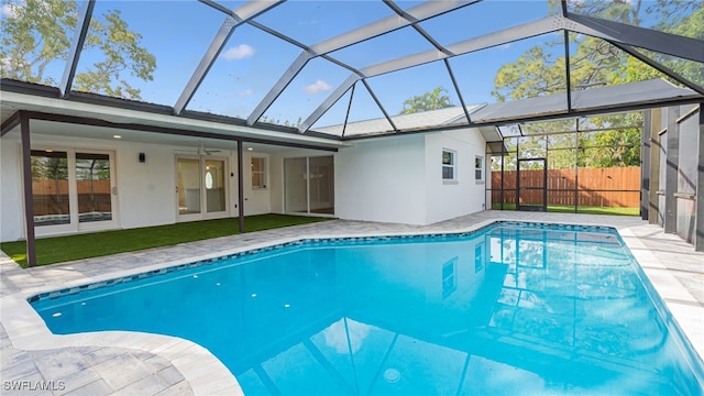 view of swimming pool with a lanai, a patio area, and ceiling fan