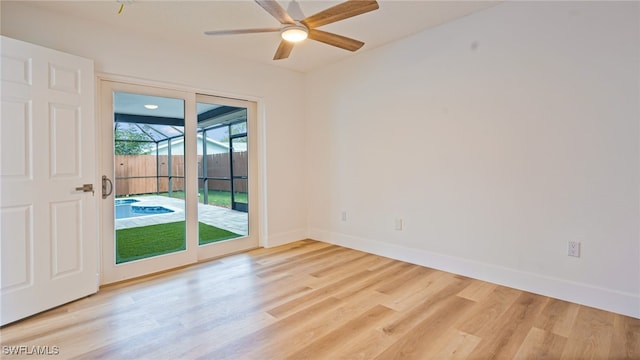 empty room featuring ceiling fan and light hardwood / wood-style flooring