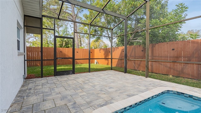 exterior space featuring a patio area and glass enclosure