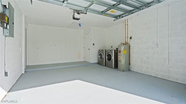 garage featuring separate washer and dryer, a garage door opener, and electric water heater