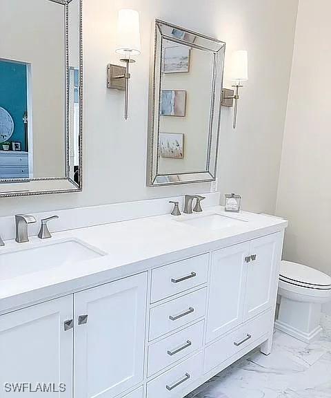 bathroom featuring vanity and toilet