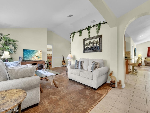 living room featuring tile patterned flooring and lofted ceiling