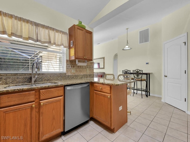 kitchen with sink, stainless steel dishwasher, kitchen peninsula, pendant lighting, and decorative backsplash