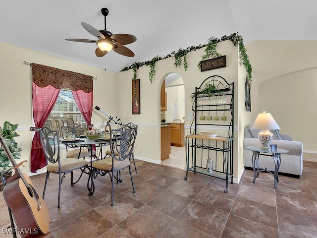 dining room with ceiling fan and lofted ceiling